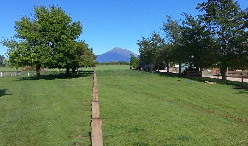 Mt Hutt seen from Methven, with a new timber post line running out toward it