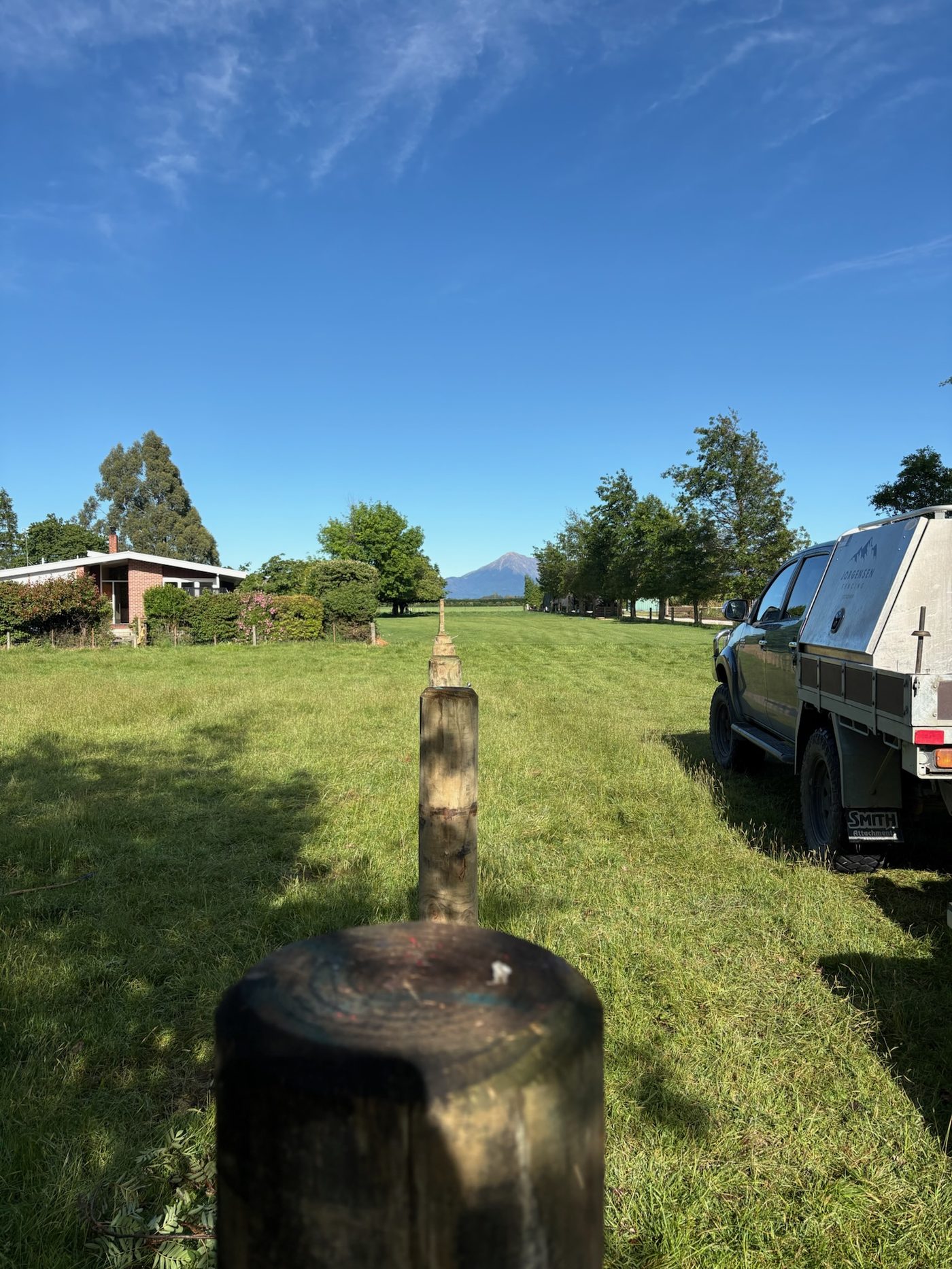 New timber post line across a lifestyle block lawn, Mt Hutt in the distance